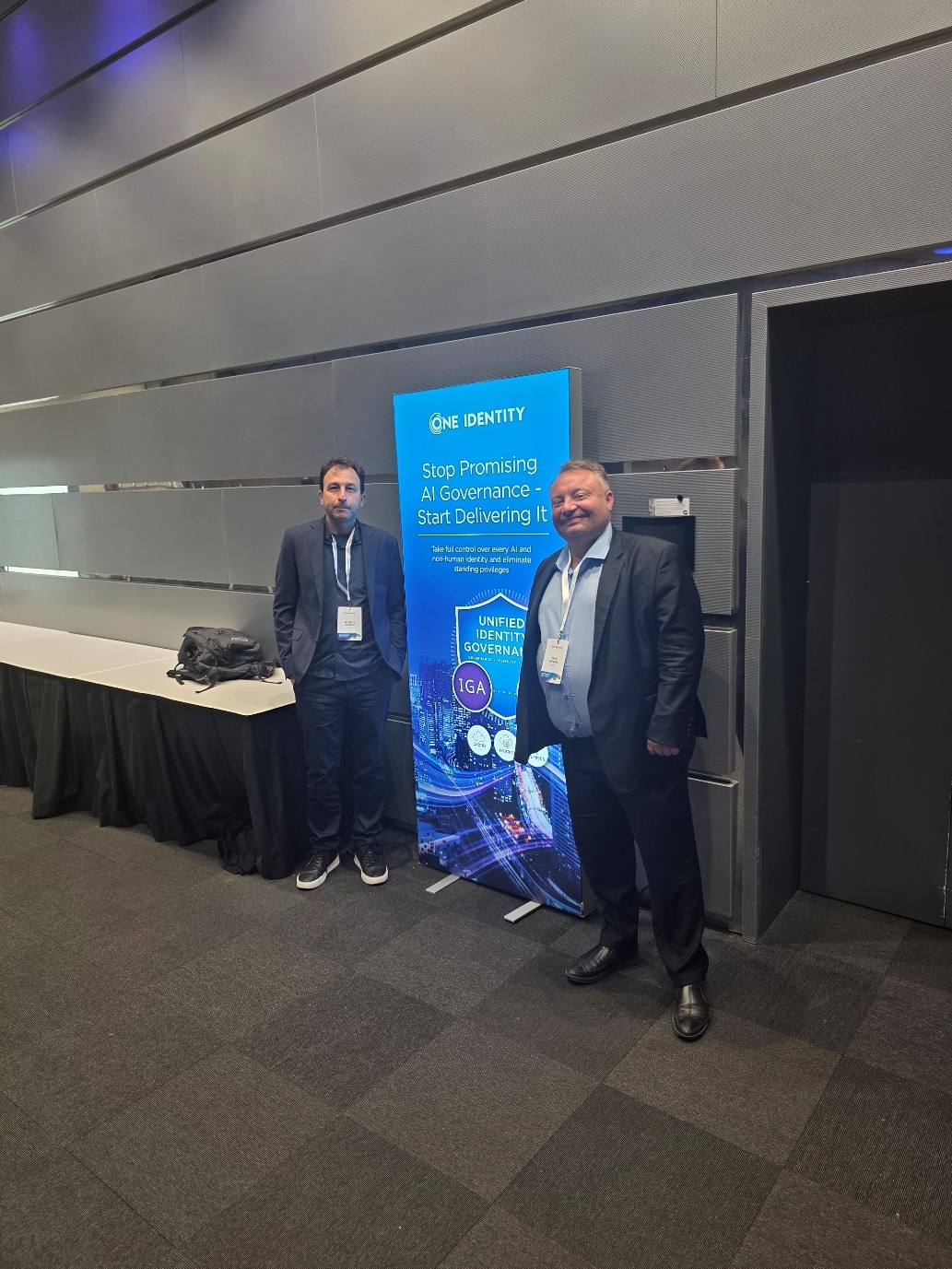 Valentin Hristov and Ivan Pepelov at the One Identity booth with the headline Stop Promising AI Governance
